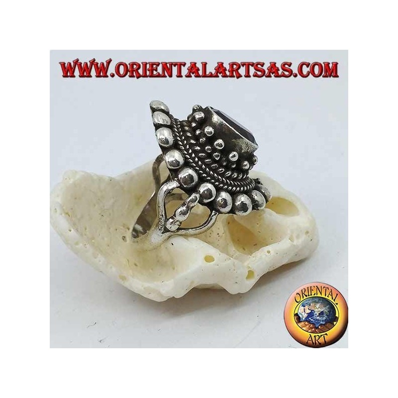 Silver ring with natural oval amethyst on a Nepalese style frame with disks and plaits