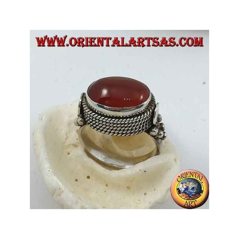 Silver ring with natural oval carnelian sideways surrounded by four rows of dots