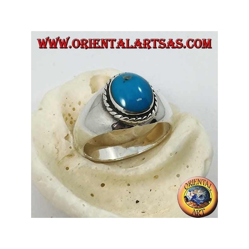 Silver ring with oval cabochon turquoise surrounded by a braid