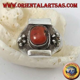 Silver ring with antique Tibetan oval coral and Nepalese setting with flower on the sides