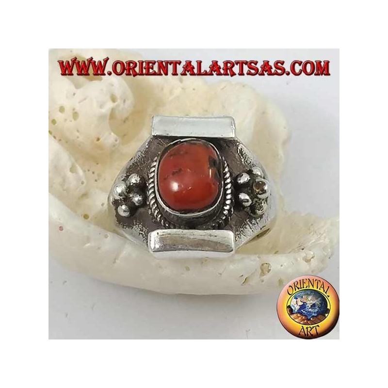 Silver ring with antique Tibetan oval coral and Nepalese setting with flower on the sides