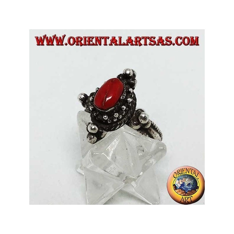 Silver ring with natural oval coral on a Tibetan setting with balls on the cardinal points