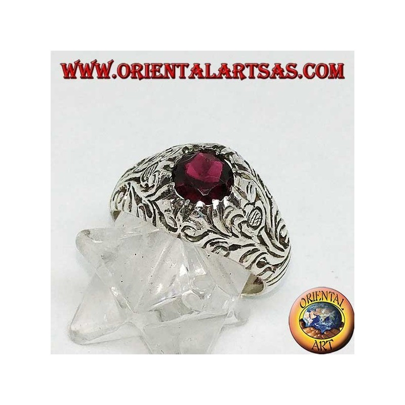 Silver ring with round natural garnet on a frame with openwork floral decoration