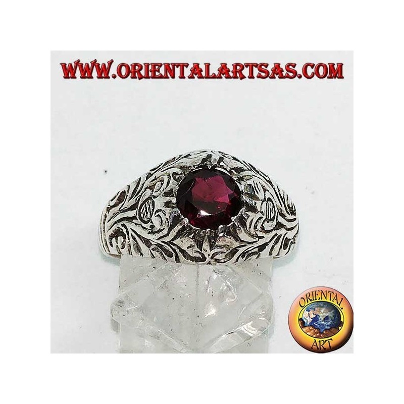 Silver ring with round natural garnet on a frame with openwork floral decoration
