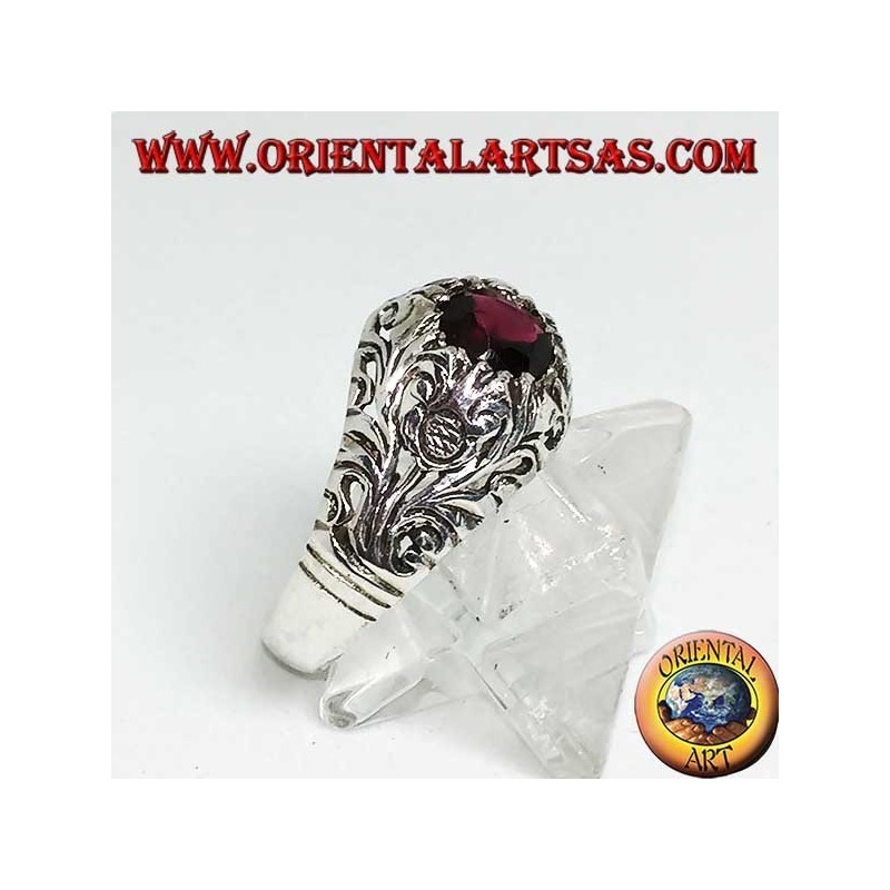 Silver ring with round natural garnet on a frame with openwork floral decoration