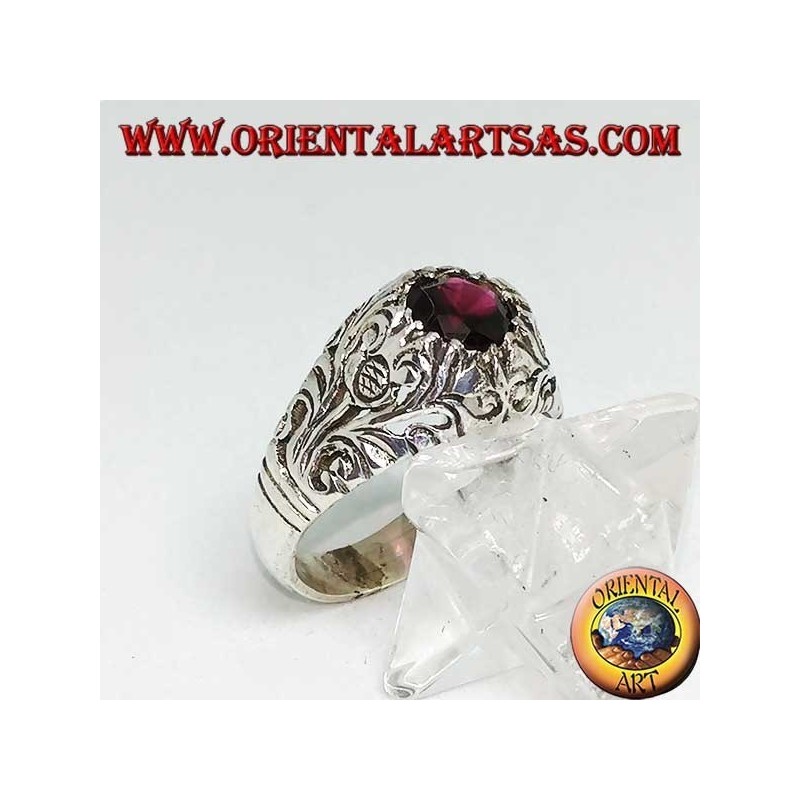 Silver ring with round natural garnet on a frame with openwork floral decoration