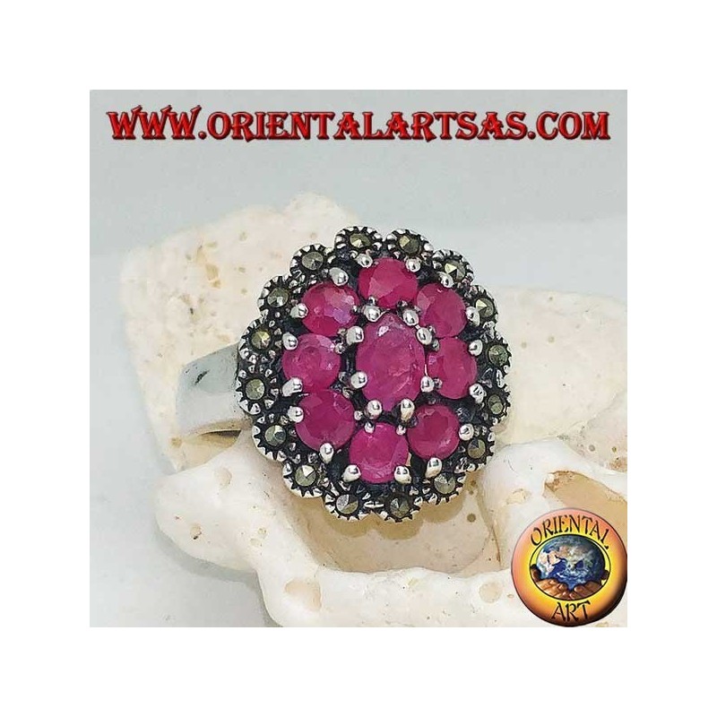 Anillo de plata con rubí natural ovalado rodeado de 8 rubíes engastados y marcasitas.