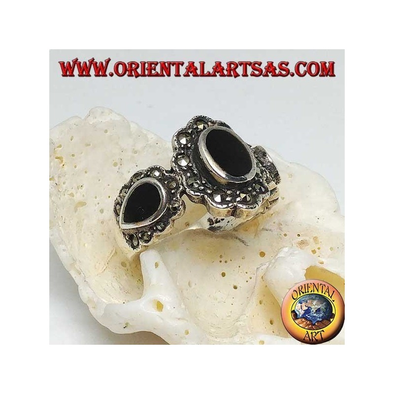 Silver ring with central oval onyx and teardrop on the sides surrounded by marcasite