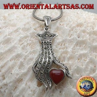 Silver pendant, carnelian heart between the fingers of a hand studded with marcasite