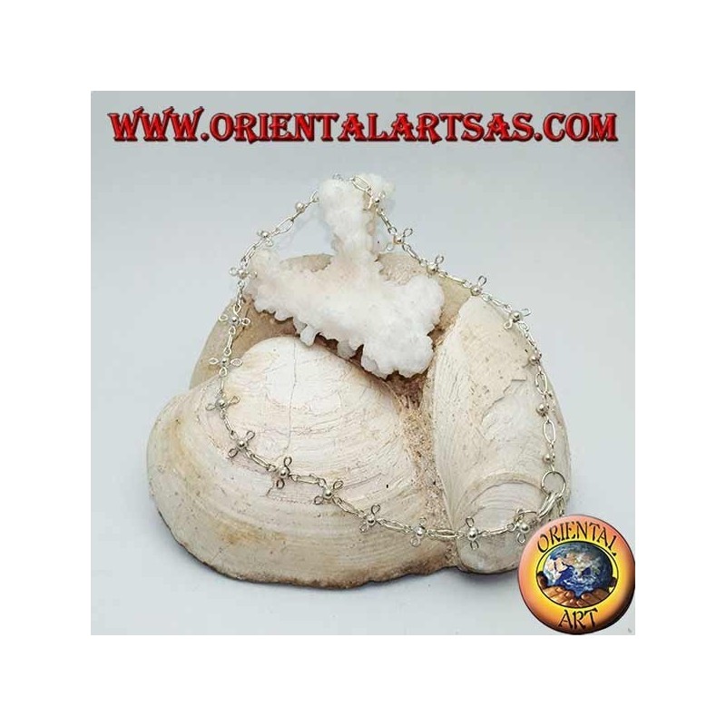 Silver anklet with stylized four-leaf clovers and a bell