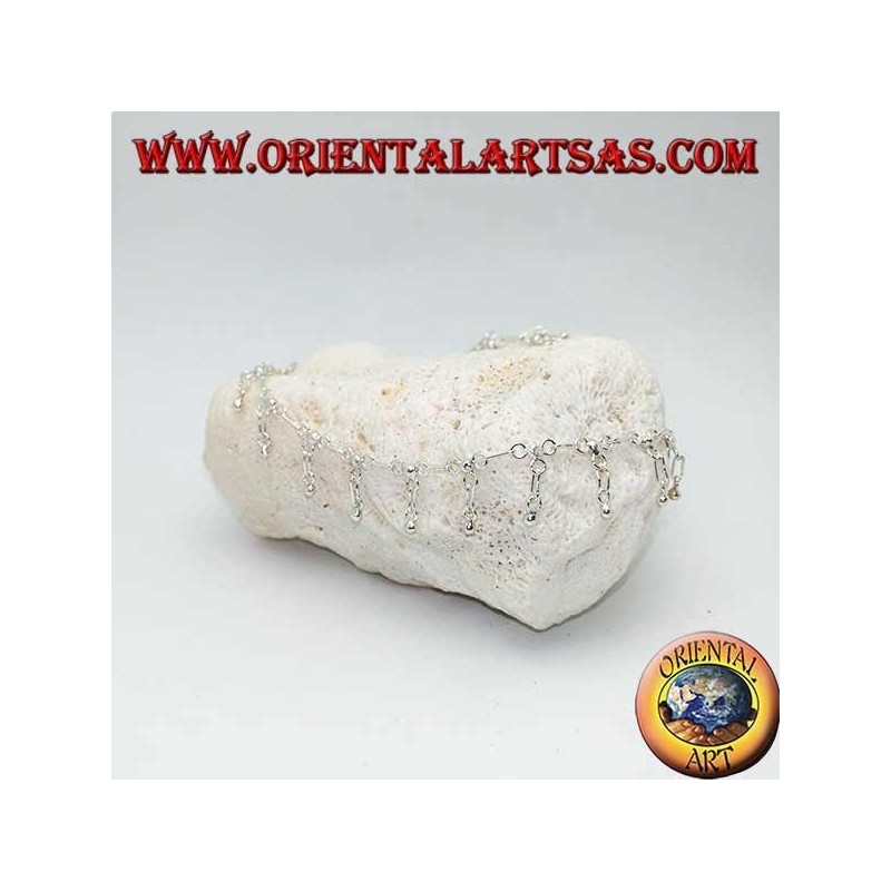 Silver anklet with hanging balls and a bell