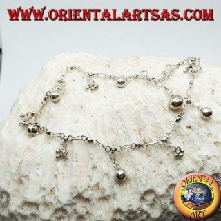 Silver anklet with groups of three balls and alternating hanging bells