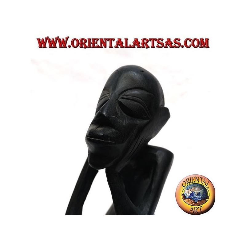 Sculpture of a seated thinker with bent legs in ebony wood