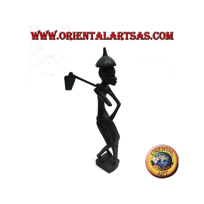 Escultura de un granjero con una azada en el hombro y un sombrero de ébano puntiagudo