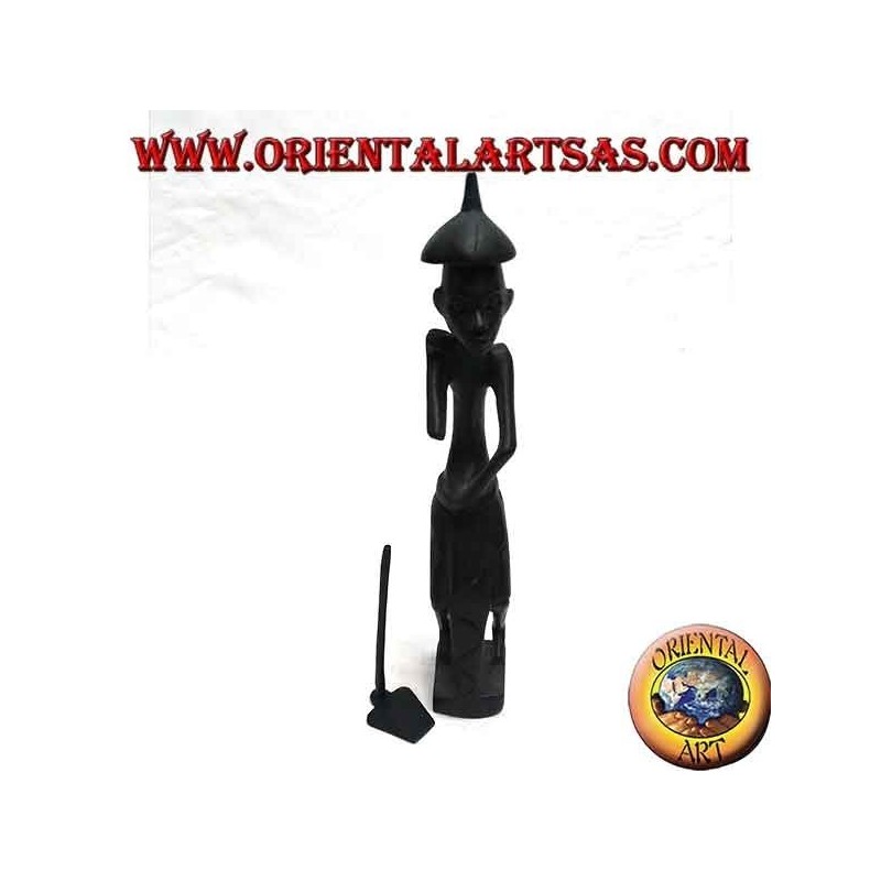 Sculpture of a farmer holding a hoe on the shoulder and a pointed ebony hat