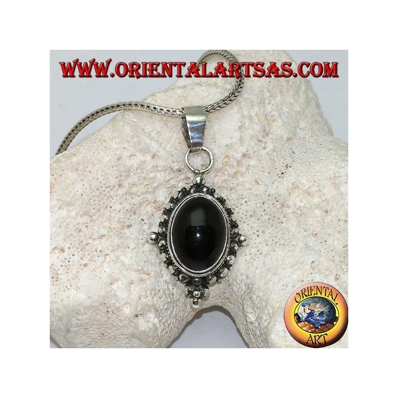 Silver pendant with oval onyx cabochon surrounded by subtle weave, dots and the four cardinal points