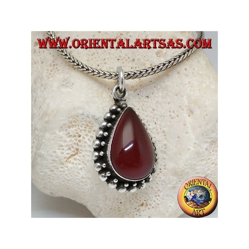 Silver pendant with teardrop cabochon carnelian surrounded by a row of small and large balls