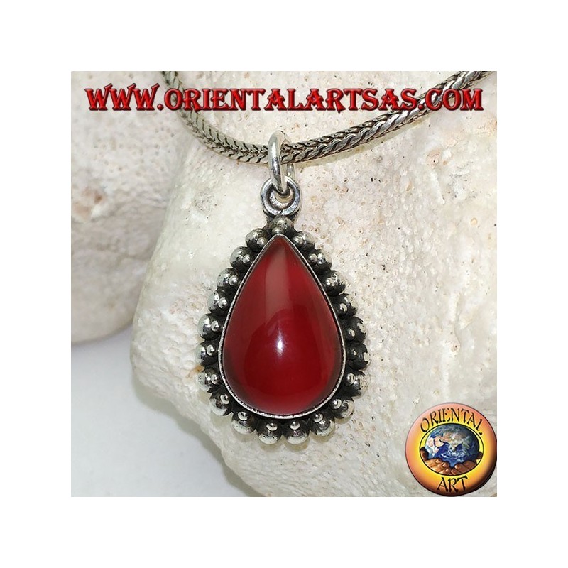 Silver pendant with teardrop cabochon carnelian surrounded by a row of small and large balls
