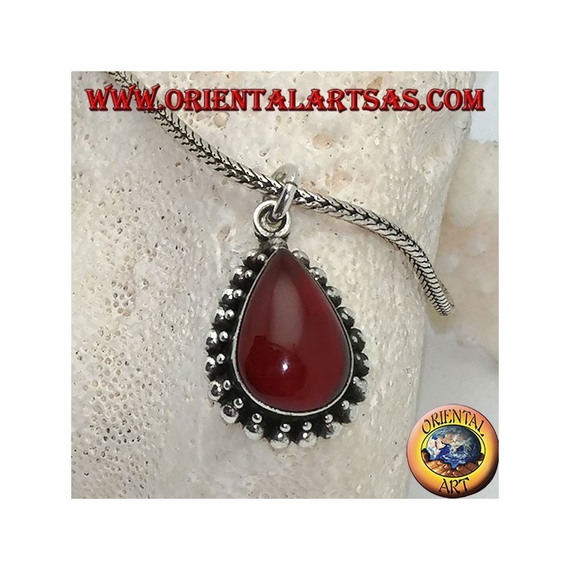 Silver pendant with teardrop cabochon carnelian surrounded by a row of small and large balls