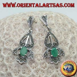 Silver earrings with natural oval emerald set on an elegant openwork frame studded with marcasite