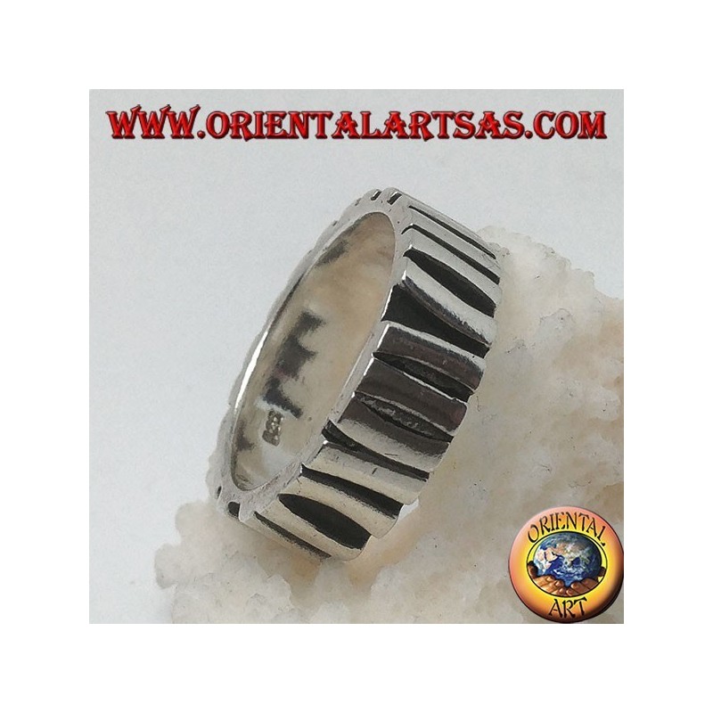 Silver band ring with a row of sticks placed parallel