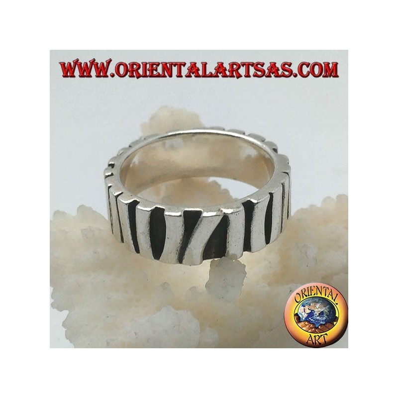 Silver band ring with a row of sticks placed parallel