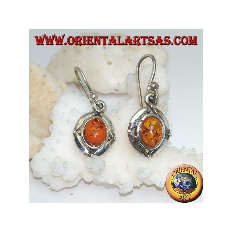 Silver earrings with oval natural amber surrounded by a disc with a ball on the cardinal points