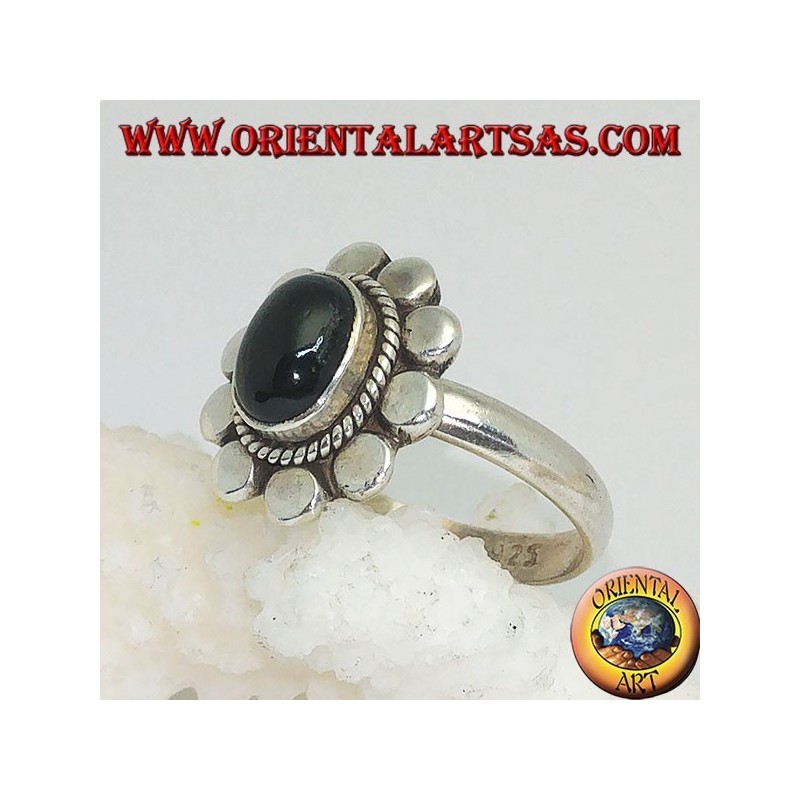 Silver flower ring with oval cabochon black star surrounded by plaiting and diskettes