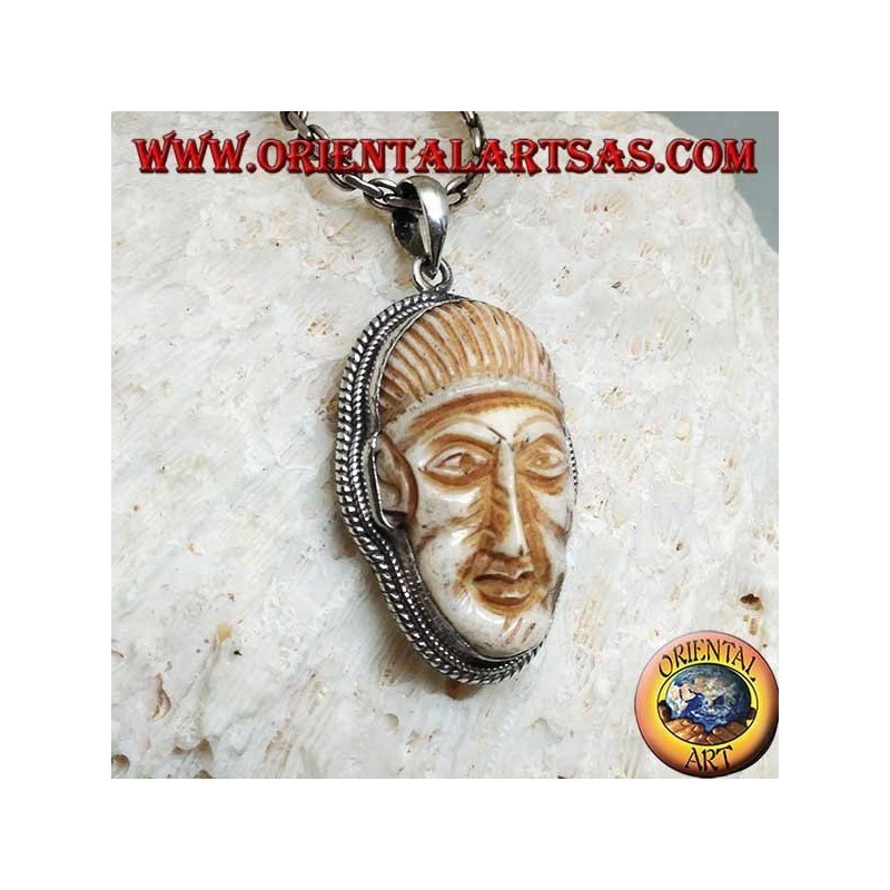 Silver pendant with a face cameo on a fang