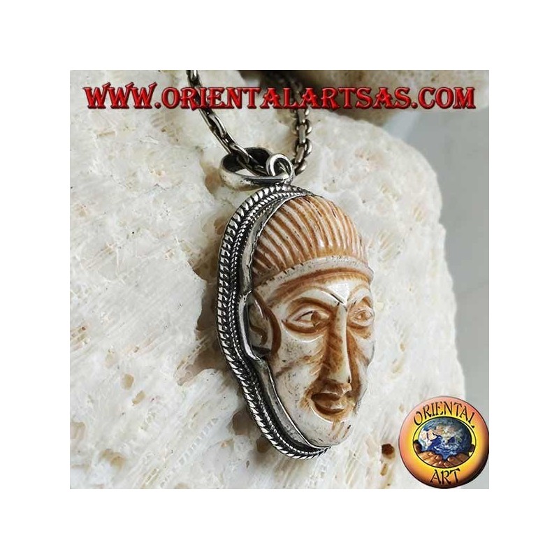 Silver pendant with a face cameo on a fang