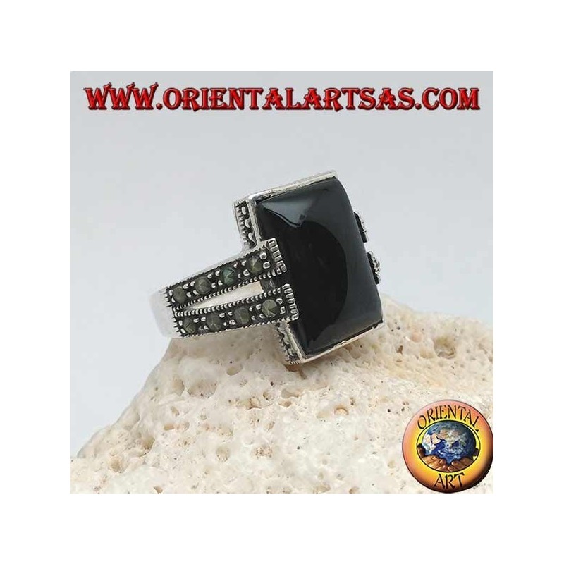 Silver ring with rectangular onyx in a dotted frame with two staples with marcasite on the sides