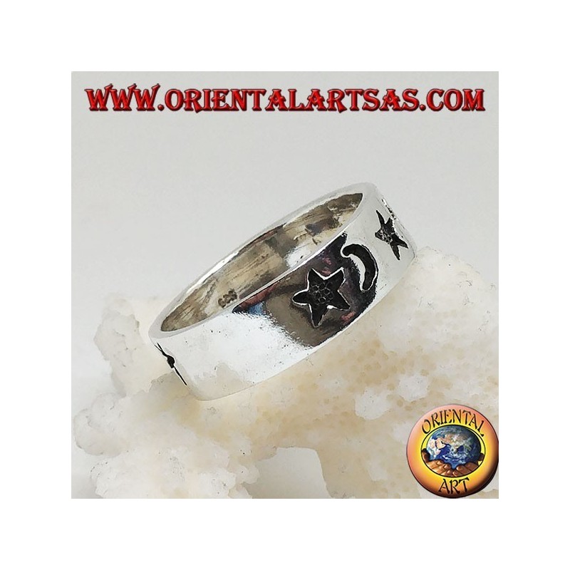 Smooth silver ring with thick engravings of stars and moons