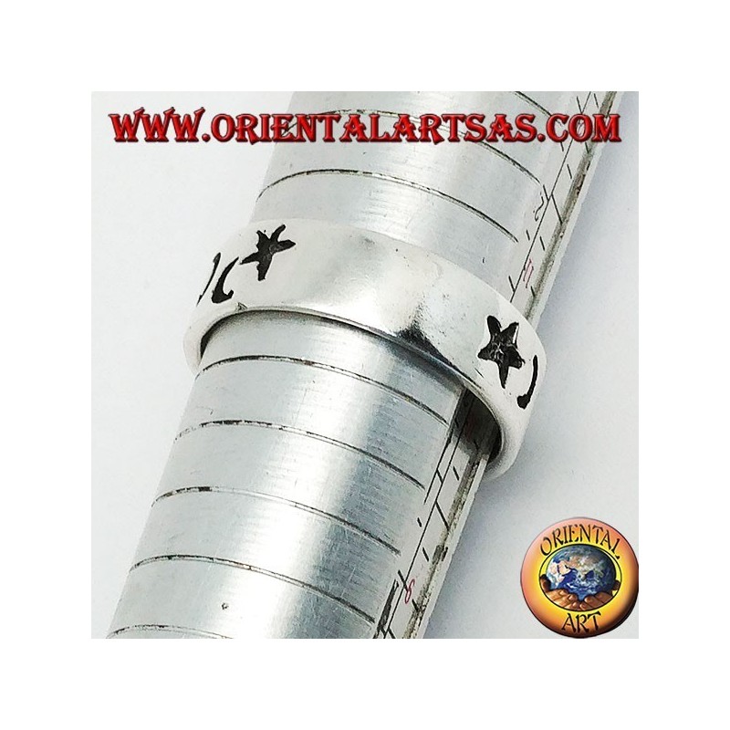 Smooth silver ring with thick engravings of stars and moons