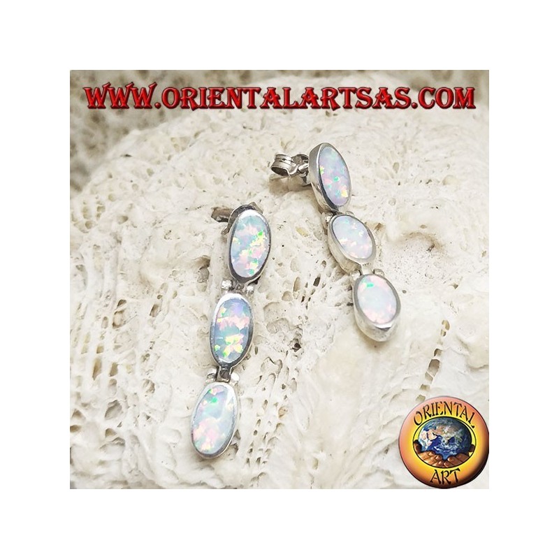 Silver lobe earrings with a row of three hanging oval white opals