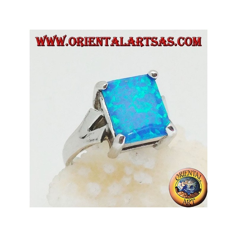 Silver ring with embedded rectangular blue fire opal and V-frame on the sides