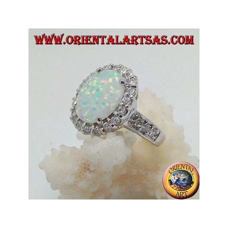 Silver ring with oval harlequin opal set with zircons around and on the sides