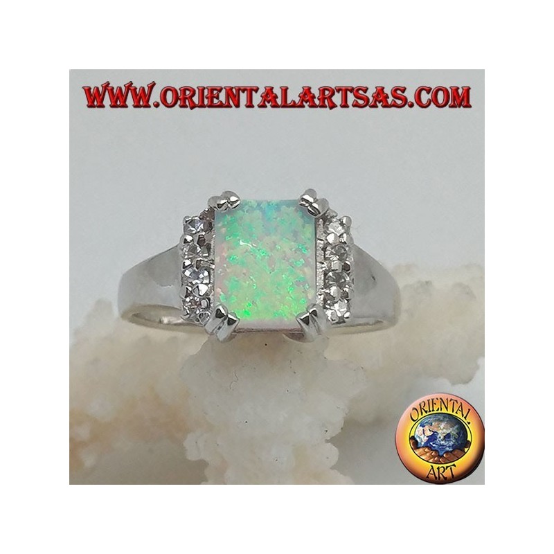 Silver ring with rectangular harlequin opal set in four and row of zircons on the sides