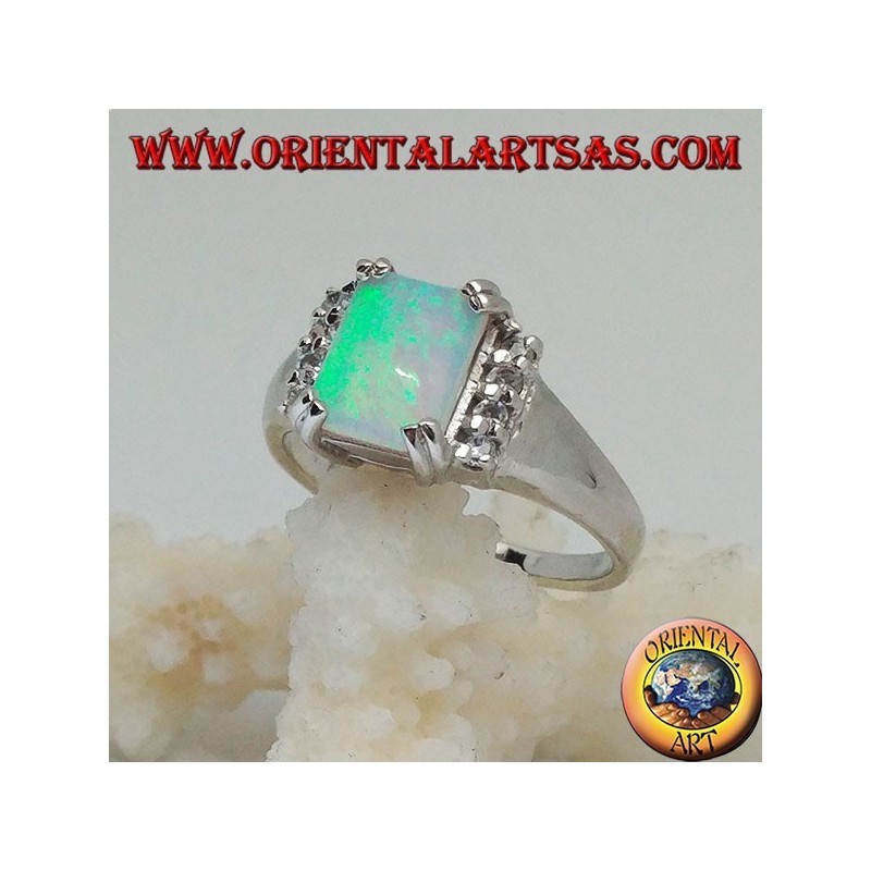 Silver ring with rectangular harlequin opal set in four and row of zircons on the sides