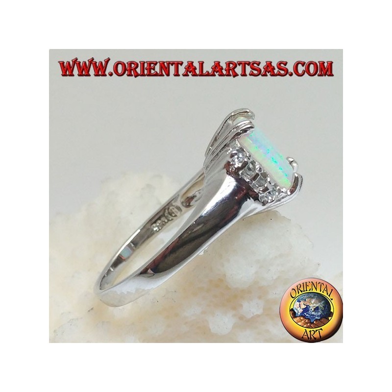 Silver ring with rectangular harlequin opal set in four and row of zircons on the sides