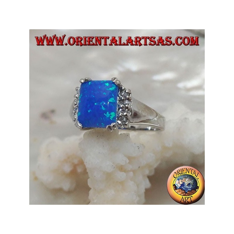 Silver ring with rectangular blue opal set in four and row of zircons on the sides