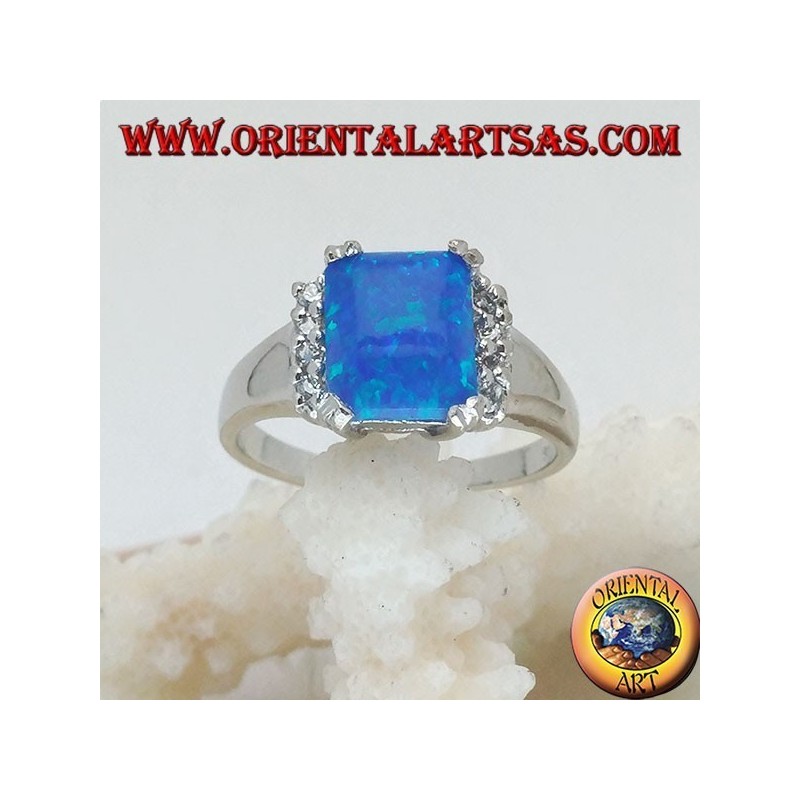 Silver ring with rectangular blue opal set in four and row of zircons on the sides