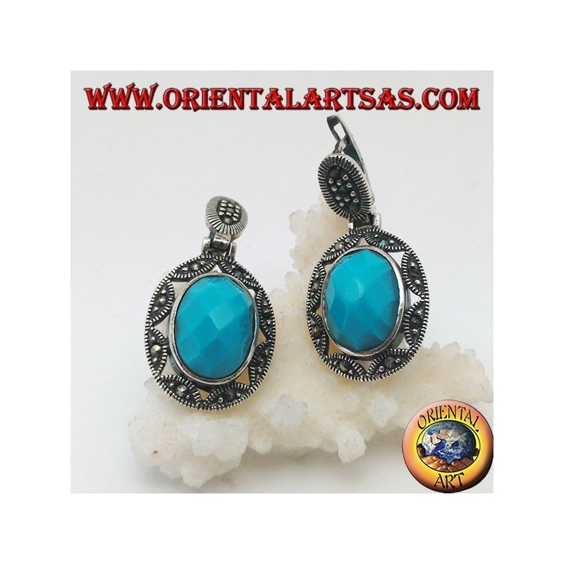 Silver earrings with oval turquoise faceted cabochon surrounded by a star and marcasite fretwork