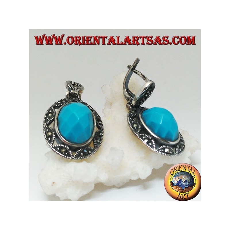 Boucles d'oreilles en argent avec cabochon ovale à facettes turquoise entourées d'une broderie d'étoiles et de marcassite