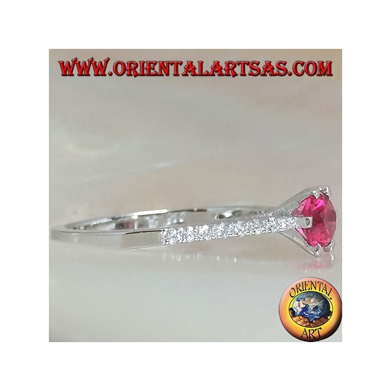 Silver ring with round synthetic ruby set on a thin row of cubic zirconia setting