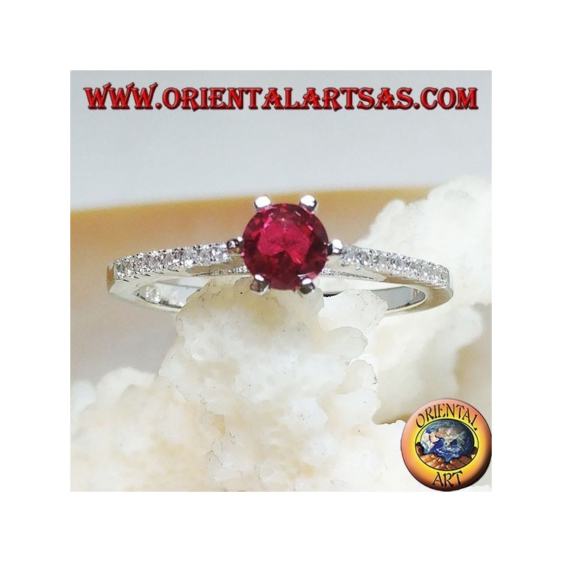Silver ring with round synthetic ruby set on a thin row of cubic zirconia setting
