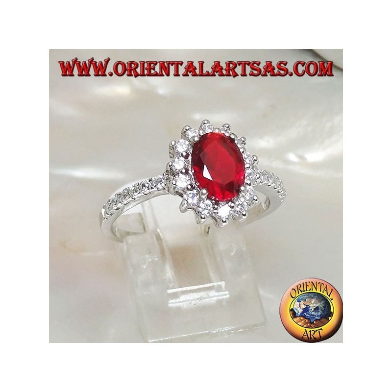 Anillo de plata con rubí sintético ovalado engastado con circonitas cúbicas y fila a los lados.
