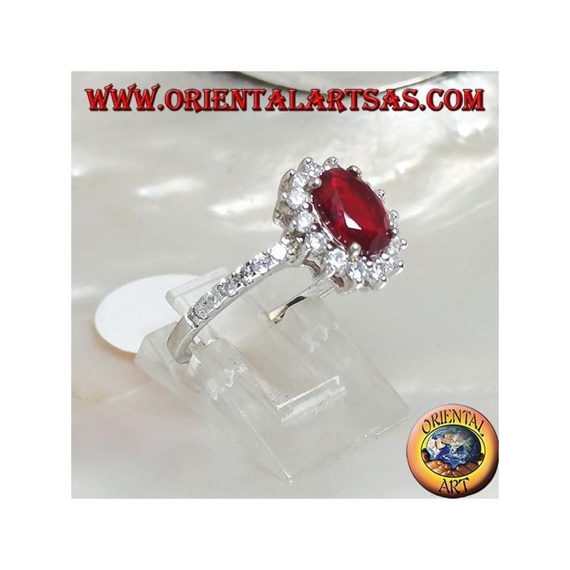 Silver ring with oval synthetic ruby set surrounded by cubic zirconia and row on the sides