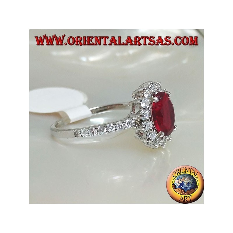 Anillo de plata con rubí sintético ovalado engastado con circonitas cúbicas y fila a los lados.
