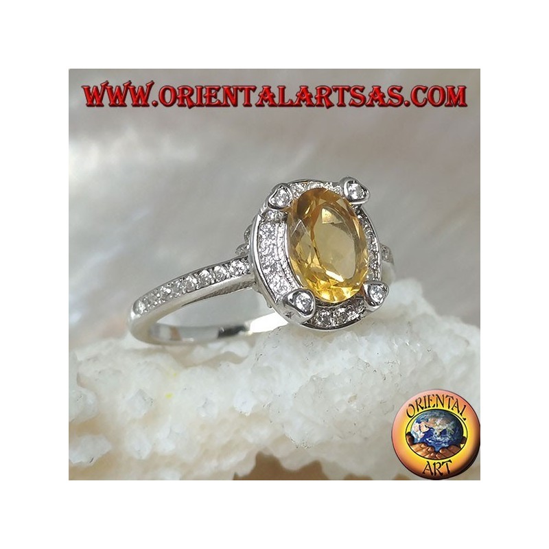 Silver ring with oval natural yellow topaz surrounded by cubic zirconia and with four cubic zirconia in relief