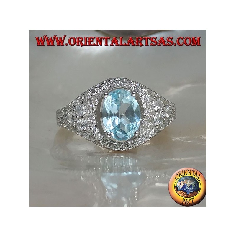 Silver ring with oval natural blue topaz on a zircon-studded frame and three rounds on the sides